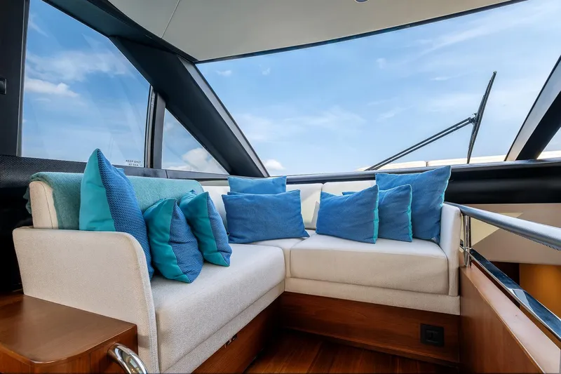  Yacht Photos Pics Luxurious interior of 2019 Princess S78 yacht with blue cushions and panoramic windows.