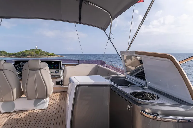  Yacht Photos Pics Luxurious 2019 Princess S78 yacht deck with seating, ocean view, and island in the background.