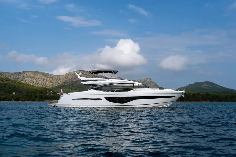  Yacht Photos Pics Luxurious 2019 Princess S78 yacht cruising on serene waters with scenic mountain backdrop.
