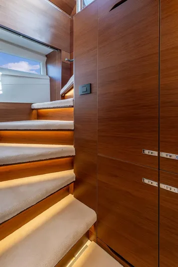  Yacht Photos Pics Luxurious wooden staircase with ambient lighting on a 2019 Princess S78 yacht.