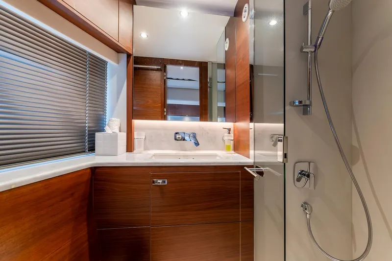  Yacht Photos Pics Luxurious bathroom interior of 2019 Princess S78 yacht with modern fixtures and wooden cabinetry.