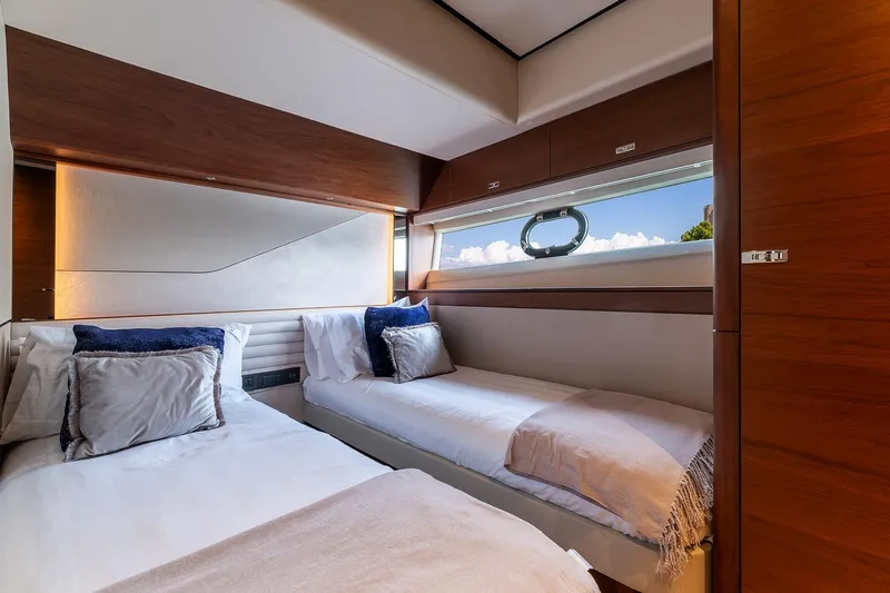  Yacht Photos Pics Luxurious twin cabin on 2019 Princess S78 yacht with elegant bedding and scenic window view.
