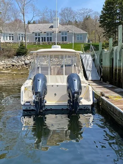  Yacht Photos Pics 2022 Grady-White 335 Freedom boat docked by a waterfront home.