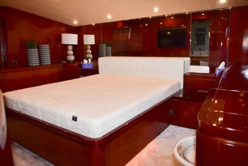  Yacht Photos Pics Luxurious bedroom interior of 2008 Falcon 102 HT yacht with elegant wood finish.