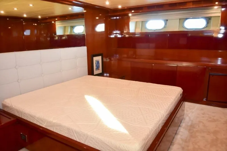  Yacht Photos Pics Luxurious bedroom interior on 2008 Falcon 102 HT yacht with wood paneling and large bed.