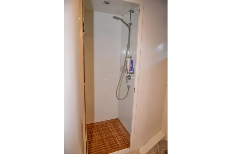  Yacht Photos Pics Compact shower area in 2008 Falcon 102 HT yacht with wooden floor mat.