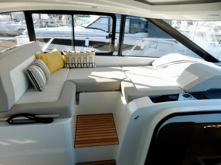  Yacht Photos Pics 2017 Jeanneau Leader 46 yacht interior with plush seating and decorative cushions.