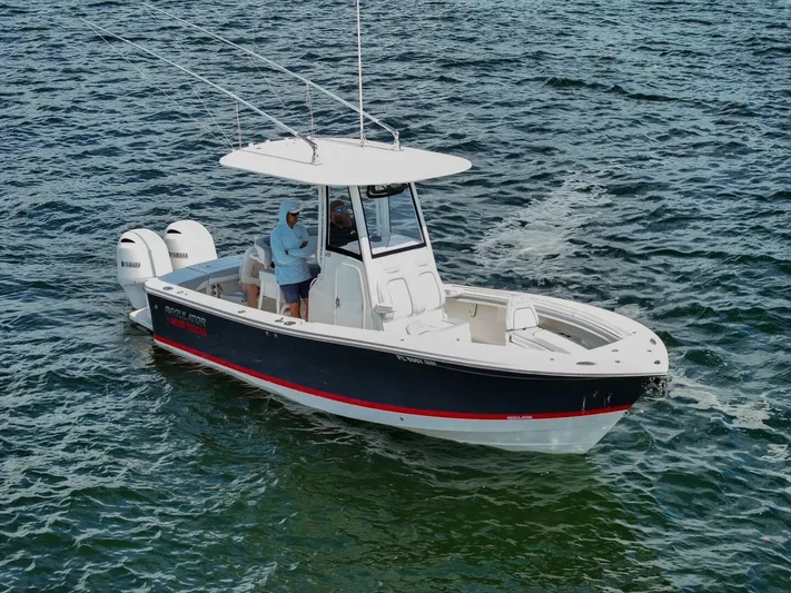 T/t Miss Texas Yacht Photos Pics 2020 Regulator 23 boat on water, featuring dual outboard engines.