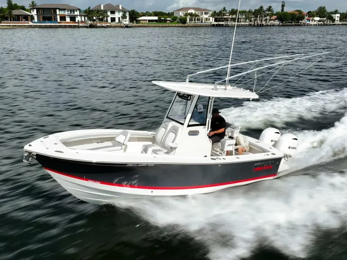 T/t Miss Texas Yacht Photos Pics 2020 Regulator 23 boat cruising on water, showcasing sleek design and powerful performance.