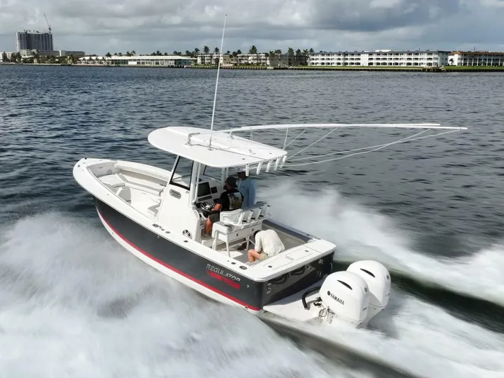 T/t Miss Texas Yacht Photos Pics 2020 Regulator 23 boat cruising on water with twin Yamaha engines.