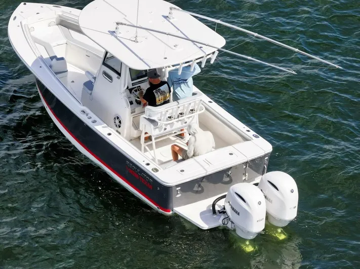 T/t Miss Texas Yacht Photos Pics 2020 Regulator 23 boat with dual engines cruising on water.