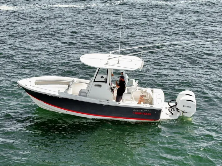 T/t Miss Texas Yacht Photos Pics 2020 Regulator 23 boat on open water, featuring sleek design and Yamaha outboard engine.