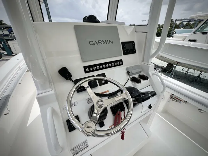 T/t Miss Texas Yacht Photos Pics 2020 Regulator 23 boat helm with Garmin navigation system and steering wheel.