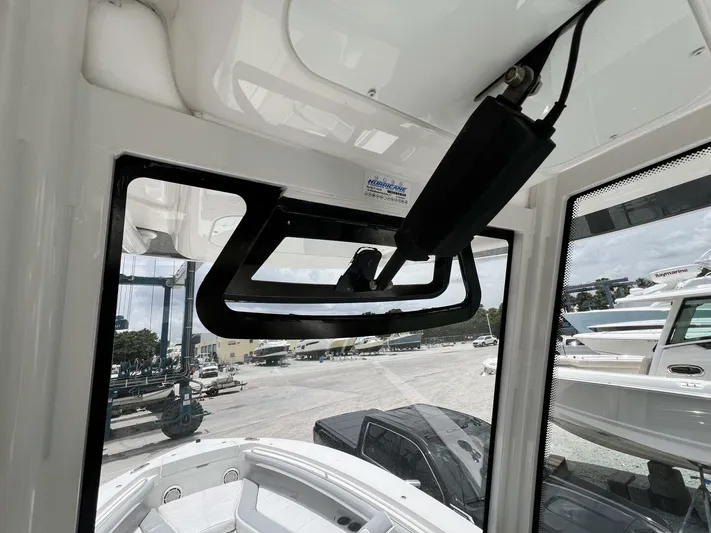 T/t Miss Texas Yacht Photos Pics Interior view of 2020 Regulator 23 boat, showcasing windshield and marina background.