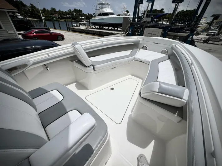 T/t Miss Texas Yacht Photos Pics 2020 Regulator 23 boat interior with cushioned seating, docked at marina.