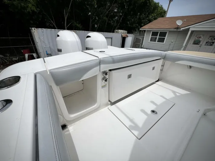 T/t Miss Texas Yacht Photos Pics 2020 Regulator 23 boat interior with dual engines and storage compartments.