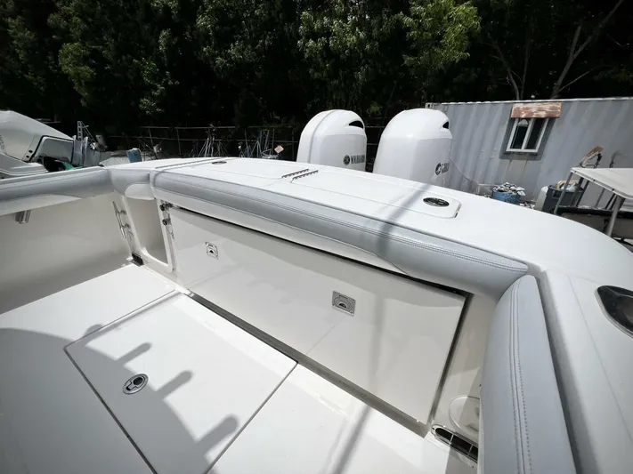 T/t Miss Texas Yacht Photos Pics 2020 Regulator 23 boat with Yamaha engines, sleek white design, outdoor setting.