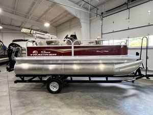 2025 Sun Tracker Bass Buggy® 16 XL Select pontoon boat in a showroom.