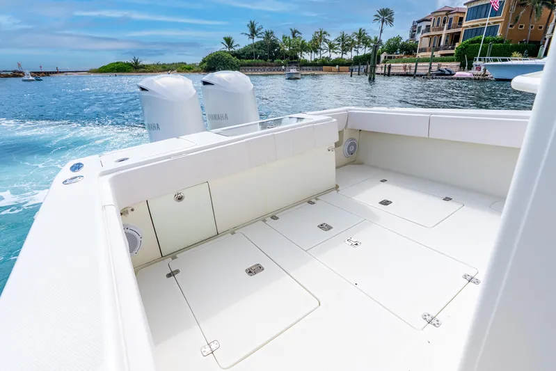  Yacht Photos Pics 2016 SeaVee 340Z boat deck with Yamaha engines, docked near luxury waterfront homes.