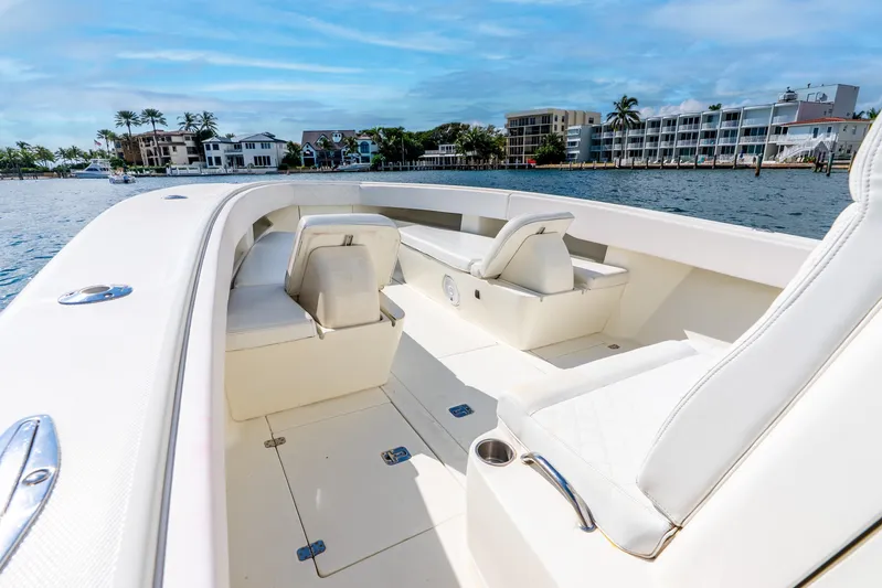  Yacht Photos Pics 2016 SeaVee 340Z boat interior with white seating, docked near waterfront homes.
