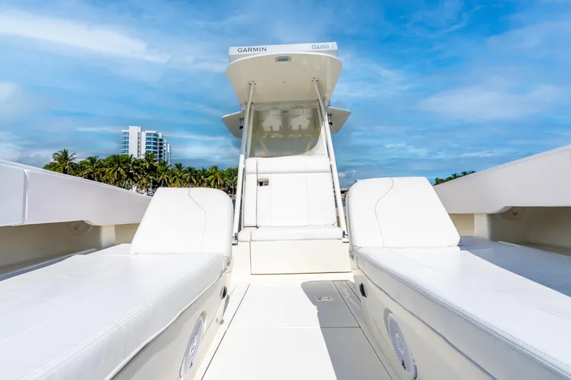  Yacht Photos Pics 2016 SeaVee 340Z boat interior with white seating, blue sky, and palm trees.