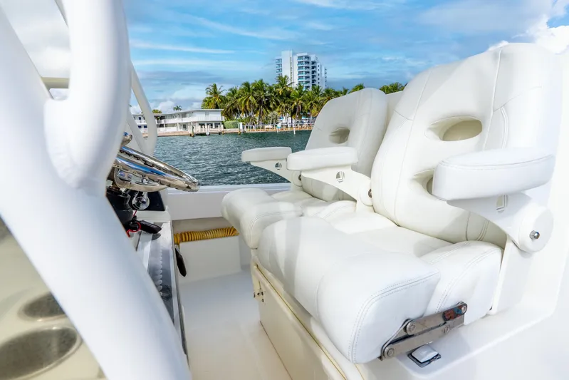  Yacht Photos Pics Luxurious white seating on 2016 SeaVee 340Z boat with scenic waterfront view.