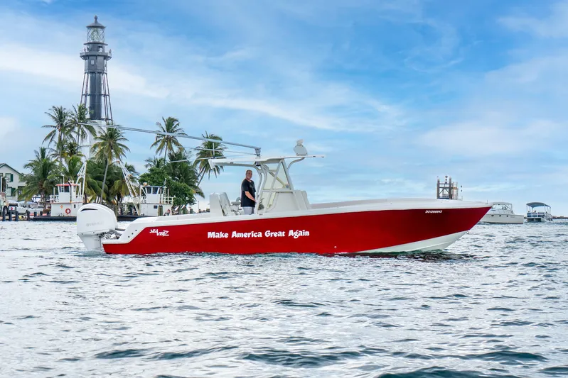  Yacht Photos Pics 2016 SeaVee 340Z boat with "Make America Great Again" slogan, near a lighthouse and palm trees.