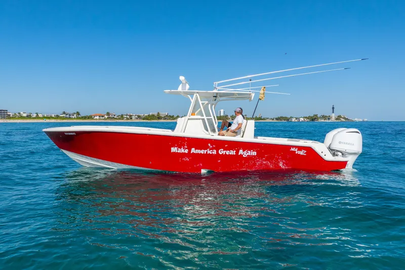 Yacht Photos Pics 2016 SeaVee 340Z boat in water, red hull, "Make America Great Again" text.