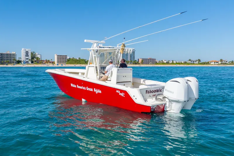  Yacht Photos Pics 2016 SeaVee 340Z boat with red hull, twin Yamaha engines, cruising near a coastal city.