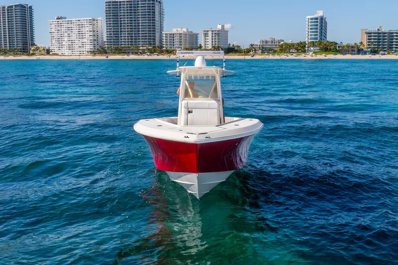  Yacht Photos Pics 2016 SeaVee 340Z boat on blue ocean, city skyline in background.