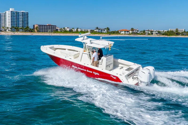  Yacht Photos Pics 2016 SeaVee 340Z boat cruising on blue ocean near coastal buildings.
