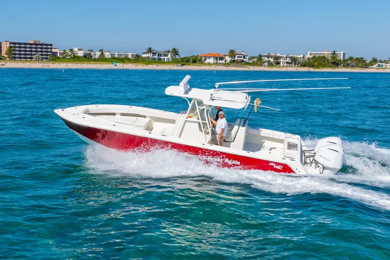  Yacht Photos Pics 2016 SeaVee 340Z boat cruising on blue ocean near coastal buildings.