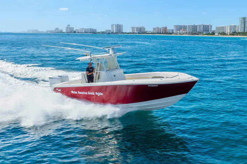  Yacht Photos Pics 2016 SeaVee 340Z boat cruising on blue ocean near city skyline.