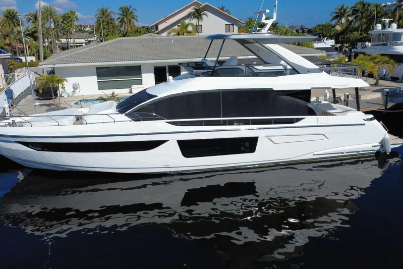  Yacht Photos Pics 2025 Azimut Fly 68 yacht docked near a modern waterfront home.