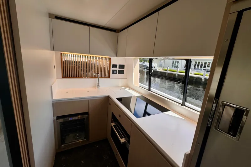  Yacht Photos Pics Modern kitchen in 2025 Azimut Fly 68 yacht with sleek design and large window view.