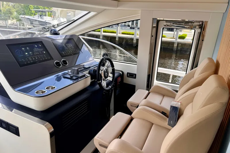  Yacht Photos Pics Luxurious interior of 2025 Azimut Fly 68 yacht with modern helm and leather seating.