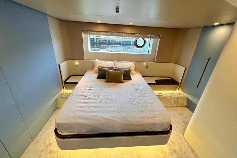  Yacht Photos Pics Luxurious bedroom interior of 2025 Azimut Fly 68 yacht with modern design and large window.