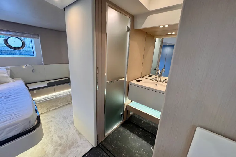  Yacht Photos Pics Luxurious interior of 2025 Azimut Fly 68 yacht featuring bedroom and modern bathroom.