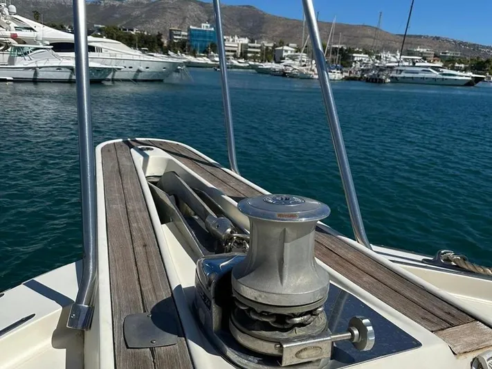  Yacht Photos Pics Bow of 1989 Hatteras 58 yacht with anchor winch, docked in marina.