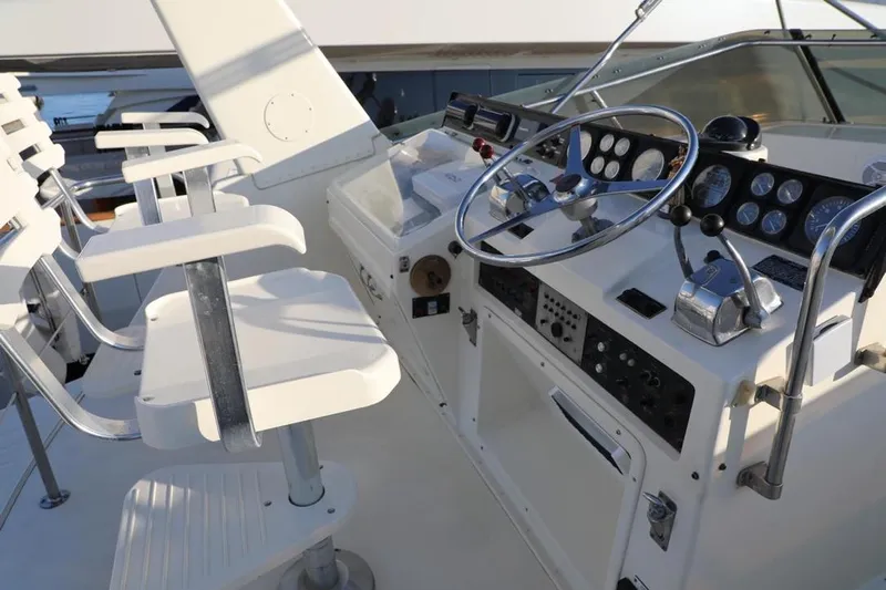  Yacht Photos Pics Cockpit of 1989 Hatteras 58 yacht with steering wheel and control panel.