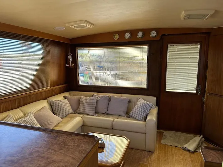  Yacht Photos Pics Luxurious interior of 1989 Hatteras 58 yacht with plush seating and elegant decor.