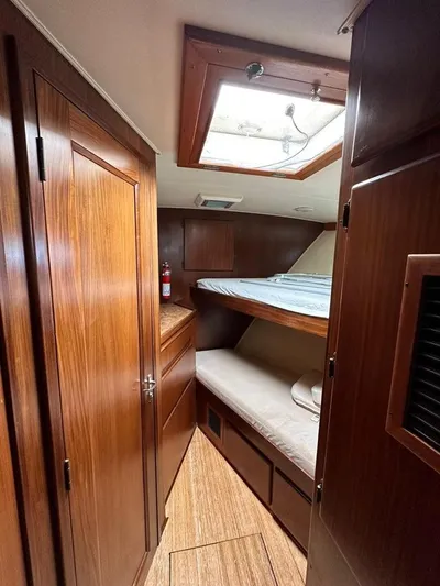  Yacht Photos Pics 1989 Hatteras 58 yacht cabin with wooden interior and bunk beds.