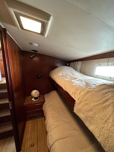  Yacht Photos Pics 1989 Hatteras 58 yacht cabin with bunk beds and wooden interior.