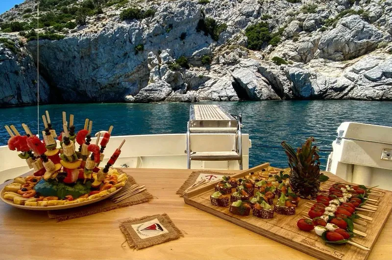  Yacht Photos Pics Gourmet appetizers on a 1989 Hatteras 58 yacht with scenic rocky coastline backdrop.