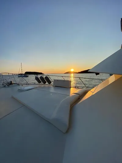  Yacht Photos Pics 1989 Hatteras 58 yacht at sunset, serene ocean view.