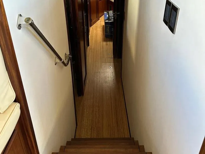  Yacht Photos Pics Stairway inside 1989 Hatteras 58 yacht with wooden flooring and handrail.