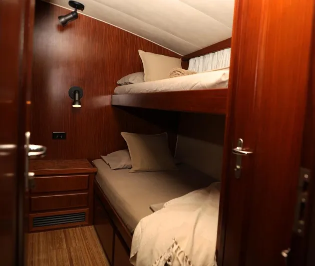  Yacht Photos Pics Cozy cabin interior of 1989 Hatteras 58 yacht with wooden bunk beds.