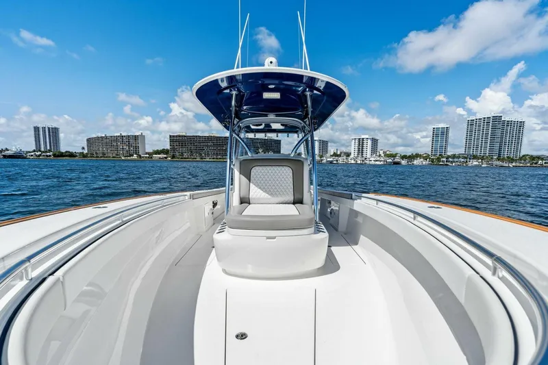 Lily Yacht Photos Pics 2021 Valhalla Boatworks V-33 on water with city skyline in background.