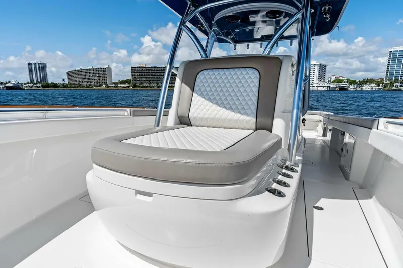 Lily Yacht Photos Pics 2021 Valhalla Boatworks V-33 with luxurious seating, docked by waterfront cityscape.
