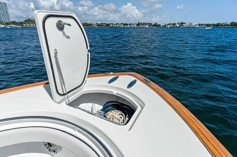 Lily Yacht Photos Pics 2021 Valhalla Boatworks V-33 with open storage compartment on calm blue water.